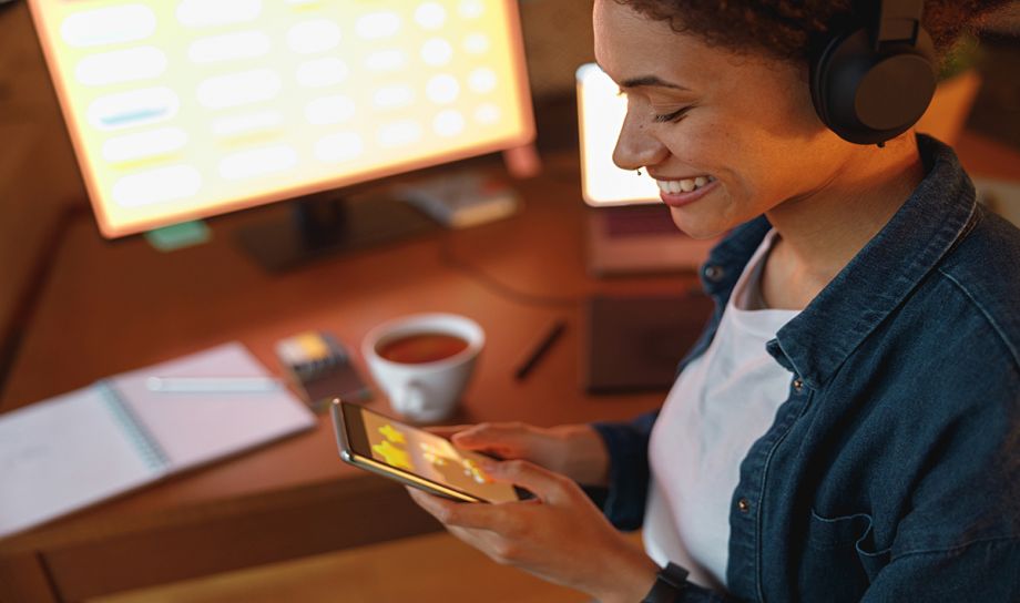 Woman looking at phone with website on screen